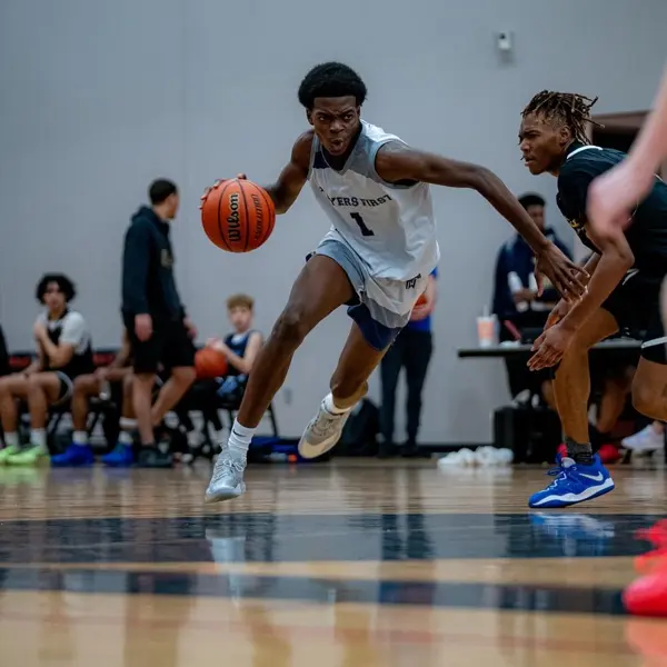 Justin Akengbowa driving to the basket in a Players First jersey
