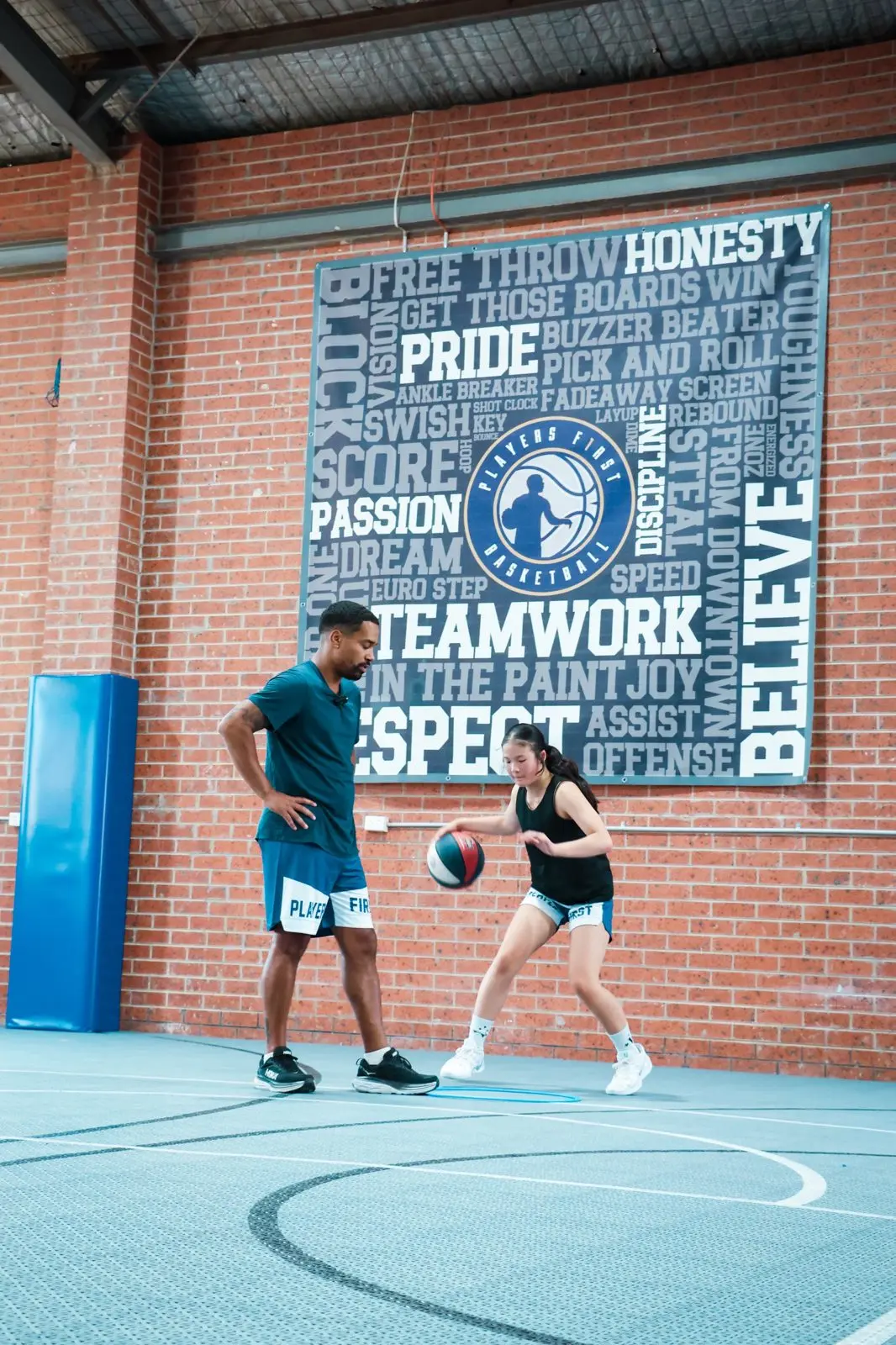 A Players First coach watching a player work on her ball handling